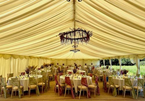 Inside of wedding marquee showing the tables dressed ready for the guests