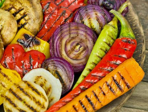 Colourful arrangement of grilled onions, peppers and mushrooms.