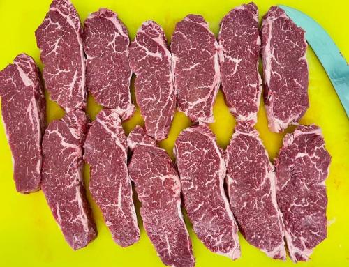 British Wagyu strip sirloin steaks showing some extensive marbling.