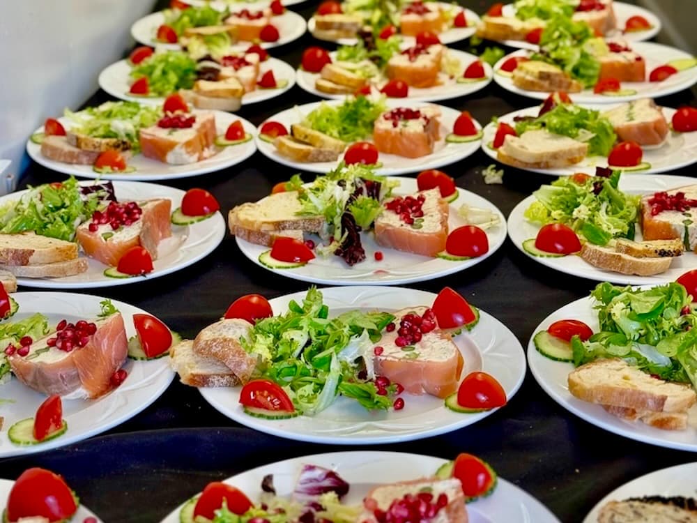 Plated smoked salmon terrine with tomato and cucumber salad and sliced bread